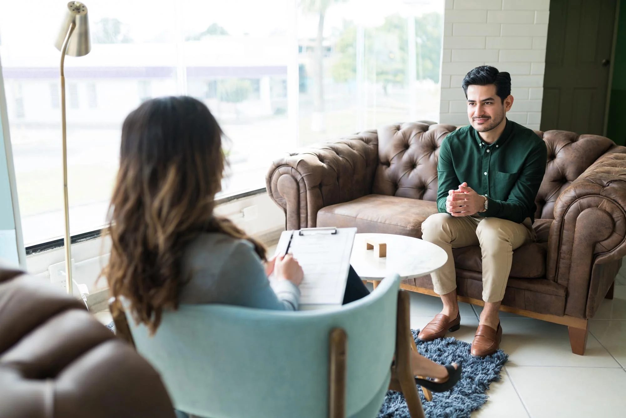 Man sits on couch across from therapist doing ERP therapy for OCD & Anxiety at Tangible Therapy
