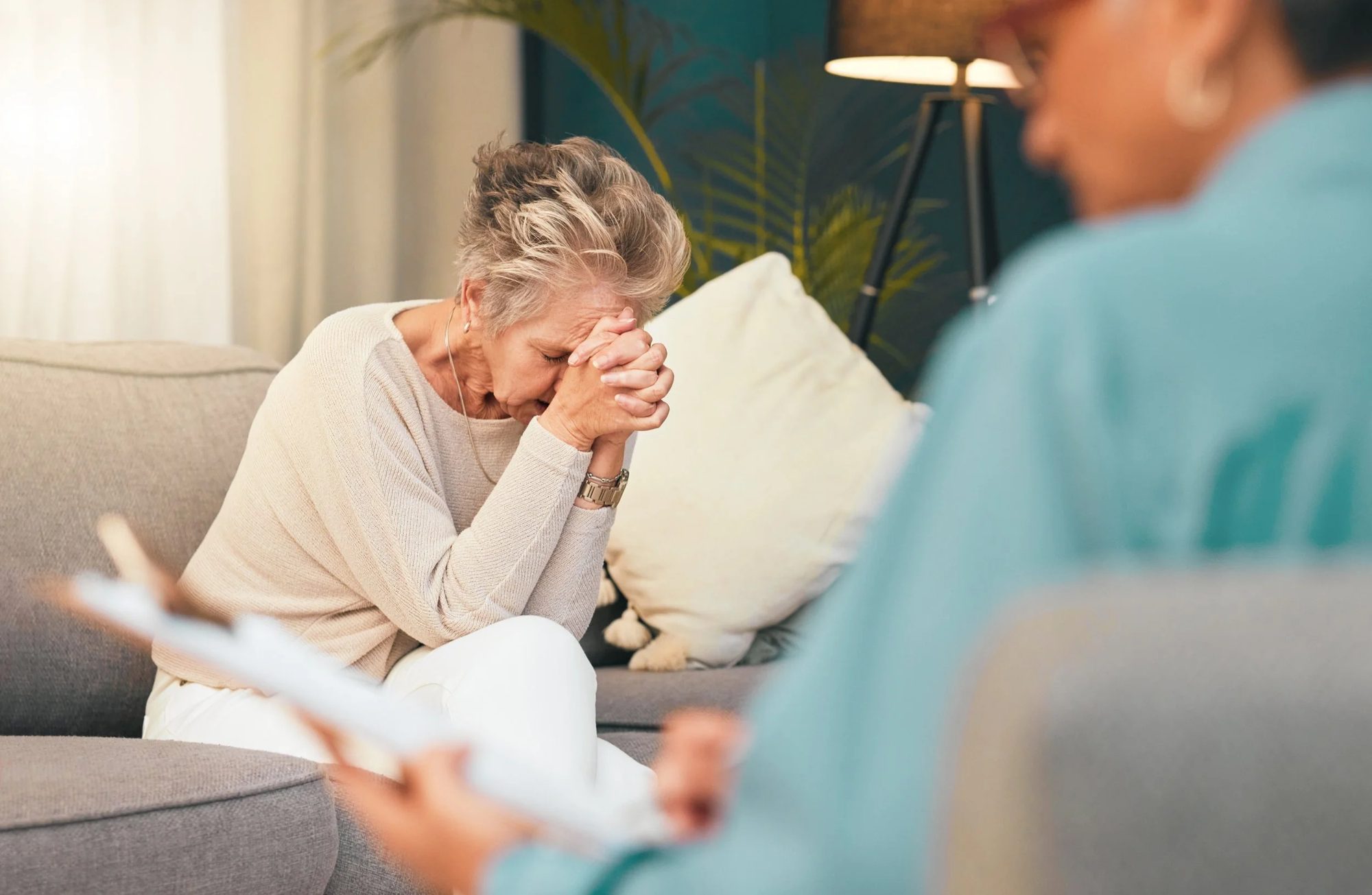 Elderly woman sits across from a therapist receiving grief counseling at Tangible Therapy