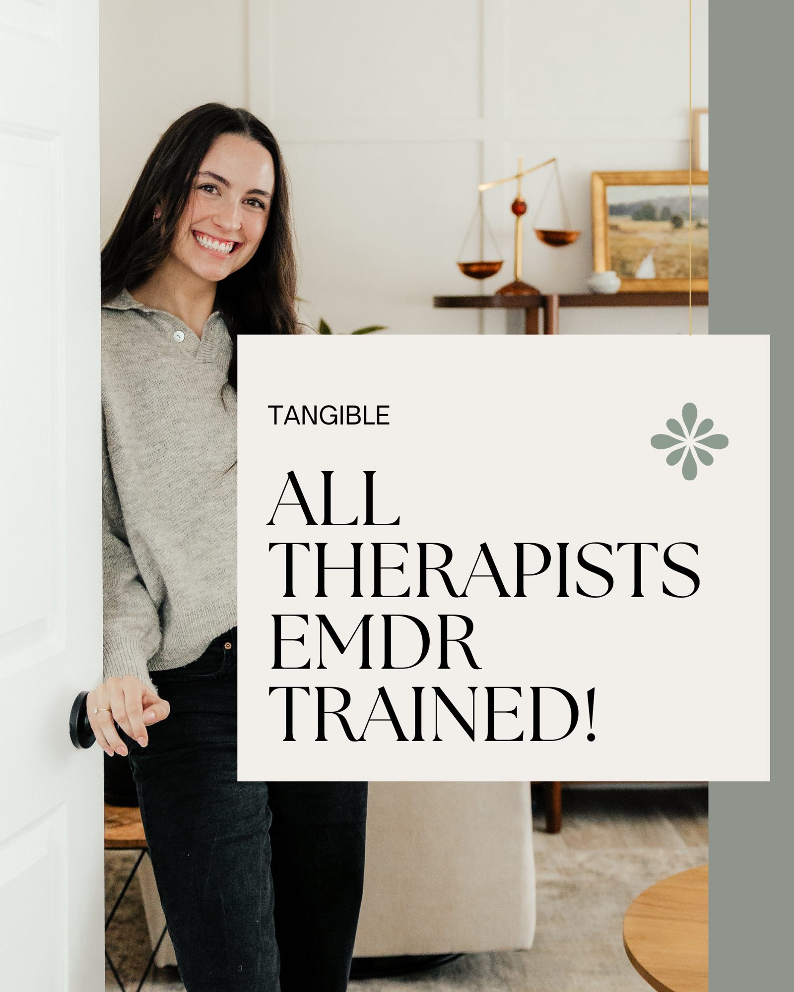 Smiling female therapist welcomes clients, behind poster about therapists being EMDR trained at Tangible Therapy in Orem & Provo Utah